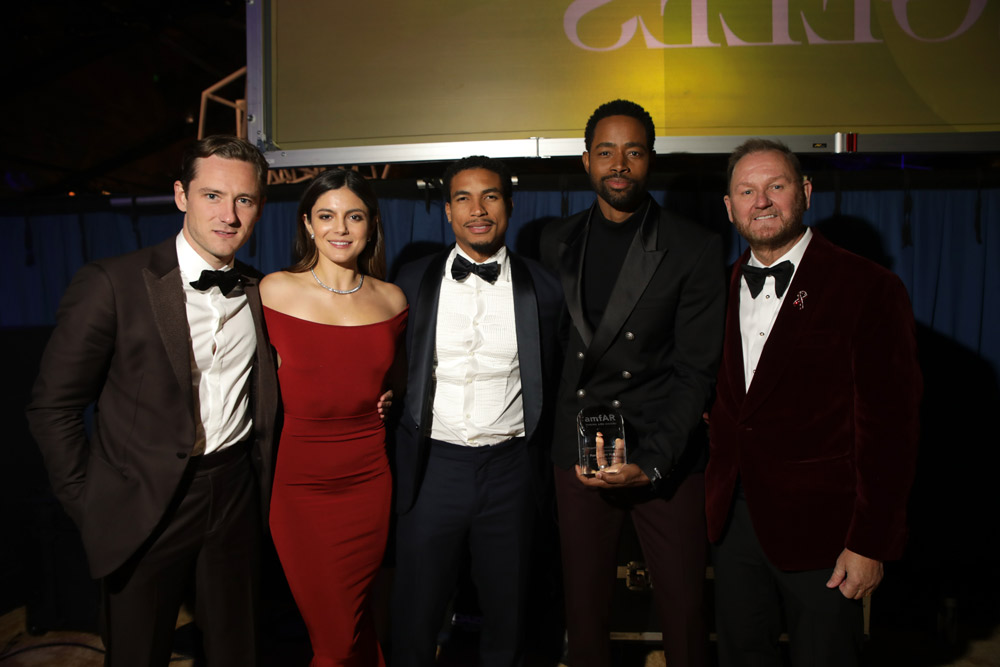 The cast of Top Gun: Maverick, Lewis Pullman, Monica Barbaro, Greg Tarzan Davis, and amfAR Trustee Jay Ellis accepted the amfAR Philanthropic Leadership Award on behalf of Paramount Pictures, with amfAR CEO Kevin Robert Frost