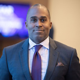 Portrait of Greg Millett, amfAR VP, from an amfAR board meeting in March 2022