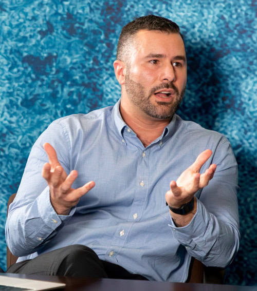 Dr. Andrea Gramatica leads a roundtable discussion with HIV researchers in New York City (photo by Colby Tallia)