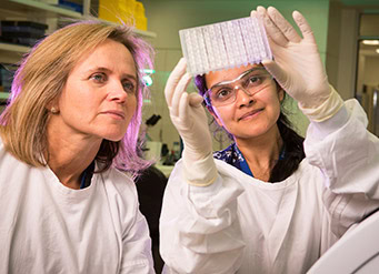 Dr. Lewin conducting HIV research in a laboratory, featured on amfAR's Corporate Partners page