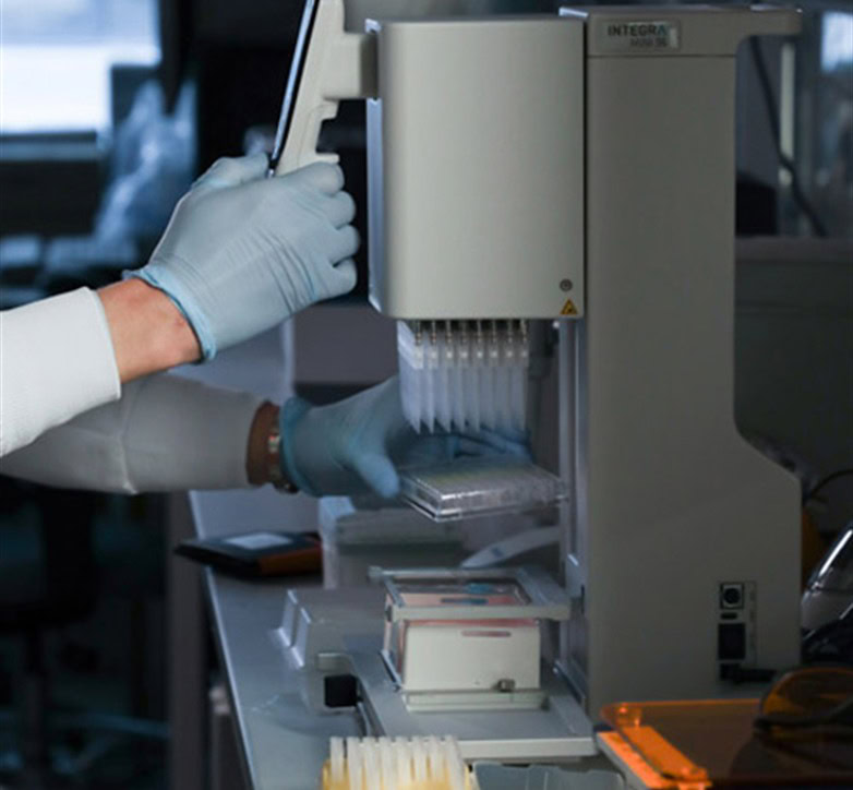Researcher using laboratory equipment, illustrating AIDS research's broader medical benefits