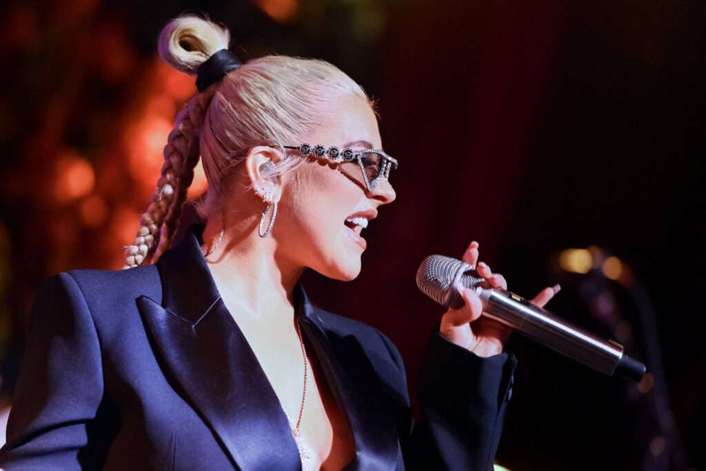 Christina Aguilera performing at an amfAR gala.