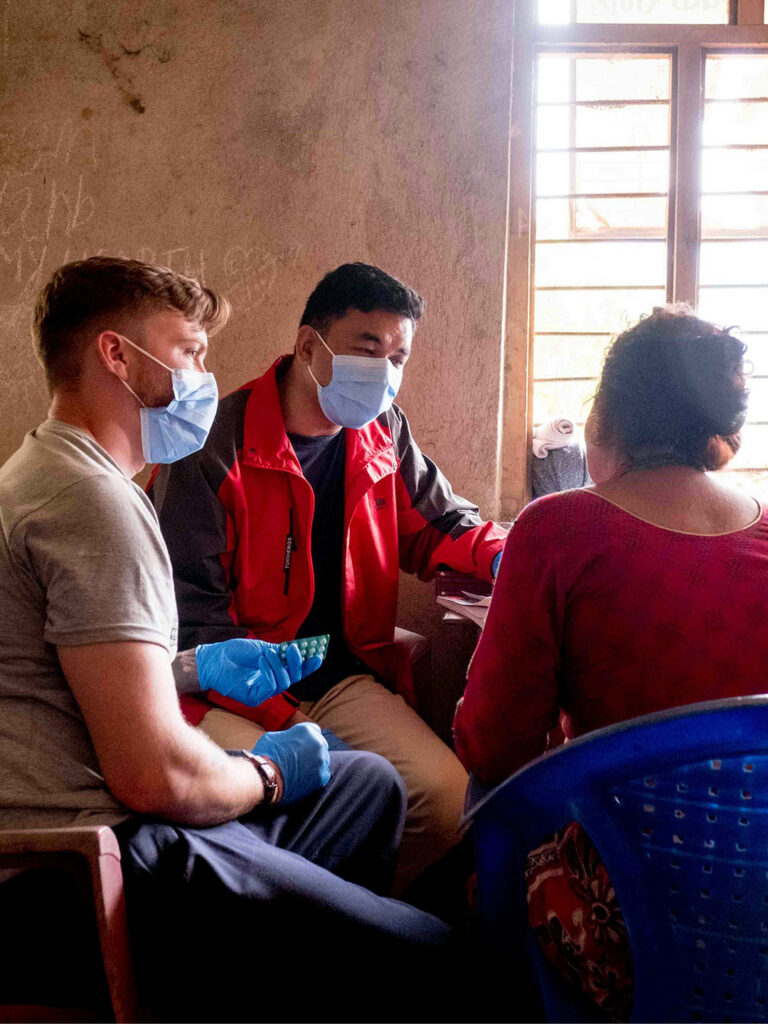 Healthcare workers and patient wearing masks during HIV consultation.